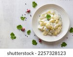 Potato salad creamy mayonnaise on wood background top view, copy space, healthy food concept.