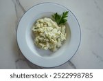 potato salad on a white marble background 