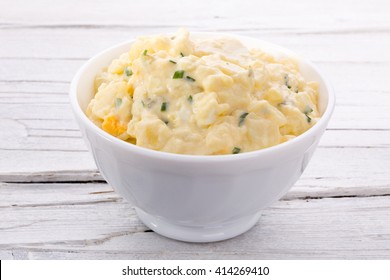 Potato Salad In White Bowl On White Wooden Background