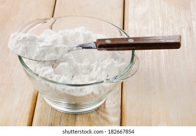 potato starch in a glass bowl on wooden table