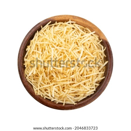 Potato straw or shoestring potato in a bowl isolated over white background.