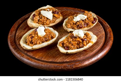 Potato Topped With Chilli Con Carne And Sour Cream Isolated On Black Background. Studio Shot