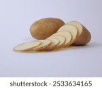 Potatoes cut into thin slices isolated on white background 