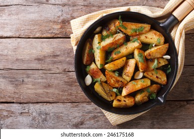 potatoes fried in a pan, rustic style, horizontal view from above 