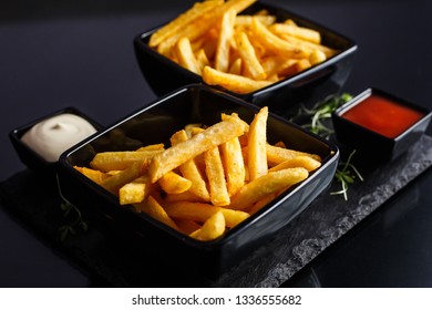 Potatoes fries in the plate on black background.