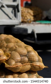 Potatoes In Mesh Bags In Wholesale Market.