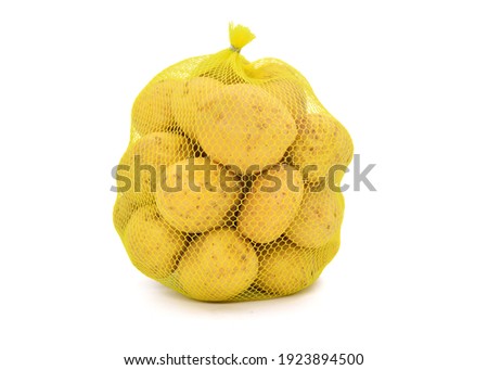 Potatoes in mesh sack isolated on white background