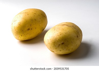 Potatoes On White Infinite Background With Shadow On The Side.