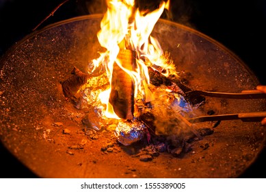 Potatoes Wrapped In Aluminum Foil Baked In A Bonfire.
