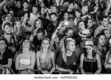 Potchefstroom, North West Province, South Africa, January 30, 2020 Concert Crowd Front Row Out Of Focus Low Light And Film Grain Black And White With Cell Phone Flash