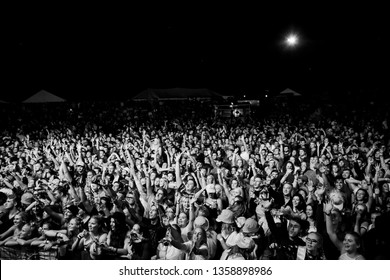 Potchefstroom, North West, South Africa 02 01 2019 Festival Show Crowd Audience In Black And White With Hands In The Air Screaming, Laughing And Dancing