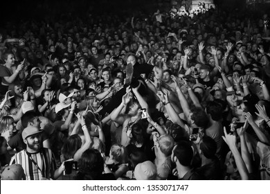 Potchefstroom, Nortwest, South Africa - 01 31 2019 live stage performance at a rock show concert singer diving in crowds surfing on hands corona virus