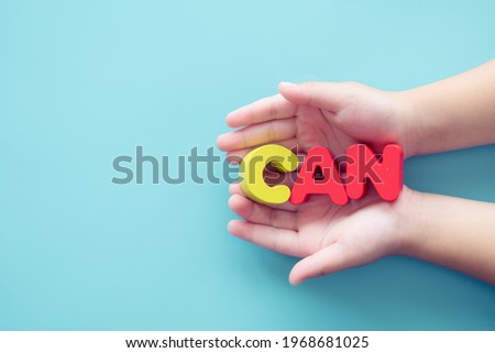 Potential energy motivation word CAN on kid hands on blue background.Child development and dream career in future.growth or change attitude yourself concept.Kid child can do.success challenge and win.