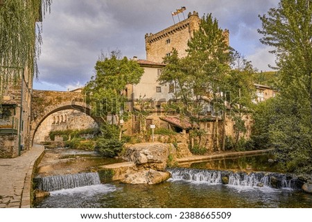Potes town with Deva river in its path and Torre del Infantado in the background. In the Liebana region, Cantabria, Spain.