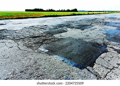 Pothole Repair On An Asphalt Road. Large Patches On The Roadway. Selective Focus