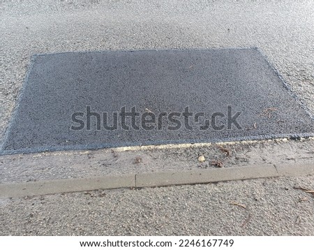 A pothole repair on a main road, Needham Market,  Suffolk, England, UK , Winter 22-23