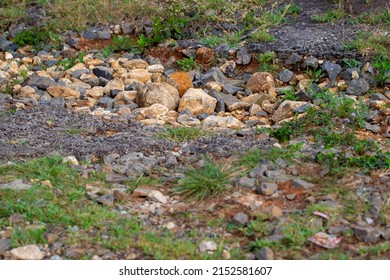 Lot Of Potholes On A Single Lane Road And Cracked Tarmac. 