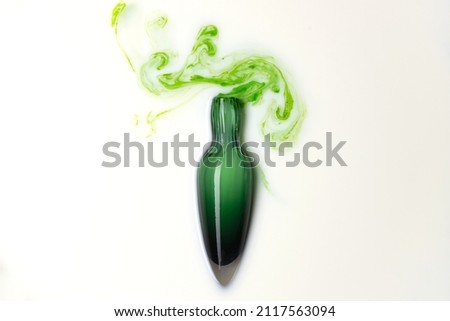 Potion in green glass flask bottle on white background. Magic wizardry elixir liquid . Witchery ingredient for healing and spell. 
