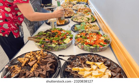 potluck spread featuring a delightful array of sandwiches, salads, and chocolate-vanilla desserts, symbolizing community, variety, and indulgence