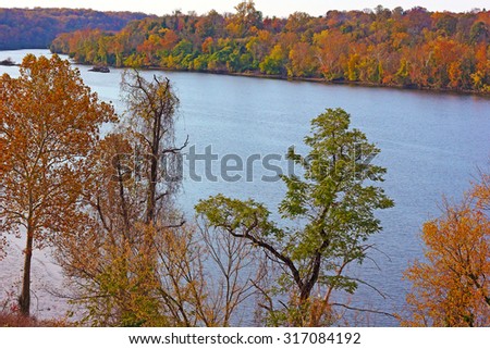 Potomac River with trees in autumn colors in Washington DC, USA. A look on Potomac River in fall from the bridge.