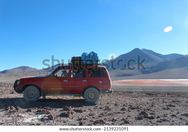 Potosi, Bolivia,\
07 14 2016\
Red utility car used to transport tourists in the\
bolivian altiplano and salar\
uyuni