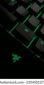 A Potrait of Kayboard Razer in the Dark Background with Green Light.