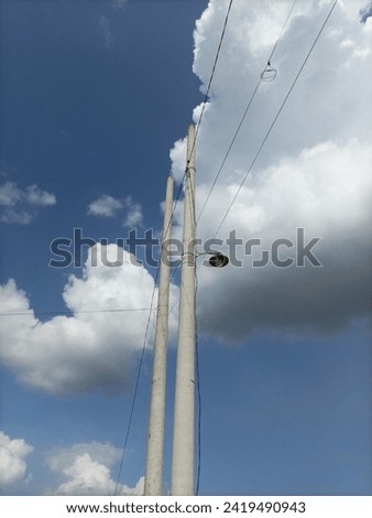 potrait power pole under blue sky low angel