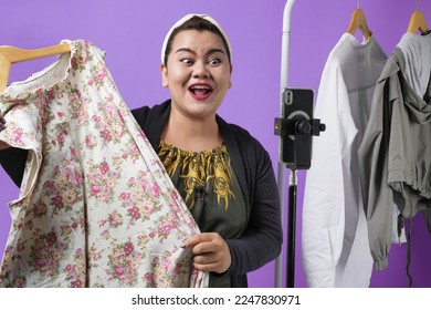 Potrait of retail store owner smile enjoy selling show live sale online screen in IG story reel tiktok work at home studio, isolated on purple background