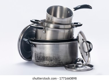 
Pots and lids used in a kitchen, stacked together on a white background. - Shutterstock ID 1771660898