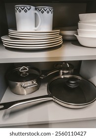 Pots and pans inside corner kitchen cabinets. High quality photo
