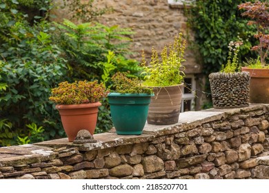 Pots With Plants On The Wall.Facade Of A Stone Building In The Village Of Dent In The Yorkshire Dales, Dent, UK