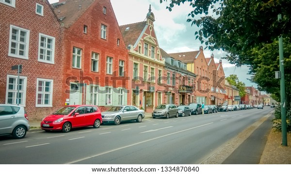Potsdam, Brandenburg / Germany - 07 25 2016: Dutch\
quarter is a neighborhood in the historical city center of Potsdam\
with holland brick merchant houses, street restaurants and\
cobblestone street. 
