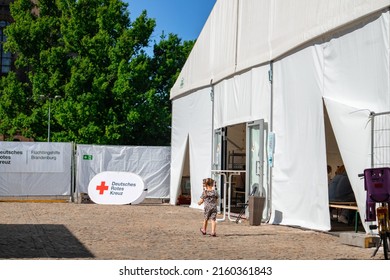 Potsdam, Germany 22 Mai 2022: A Child Near The Tent Of The Red Cross Society, Volunteer Assistance For Refugees From Ukrina. High Quality Photo