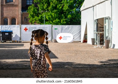 Potsdam, Germany 22 Mai 2022: A Child Near The Tent Of The Red Cross Society, Volunteer Assistance For Refugees From Ukrina. High Quality Photo