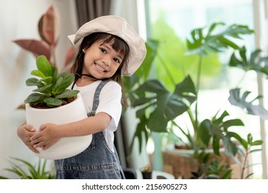 Potted plants at home held by a cute kid - Powered by Shutterstock