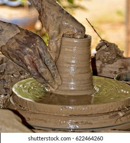 Potter busy making a pot. Potter works with clay by hands. Handmade terracotta pot. Craftsmanship. Close up