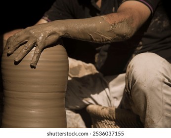 A potter keeping alive the ancient tradition of making pots or pottery using his bare hands. Pottery sculpting is one the many ancient dying industries and need help. It is 100% environmental friendly - Powered by Shutterstock