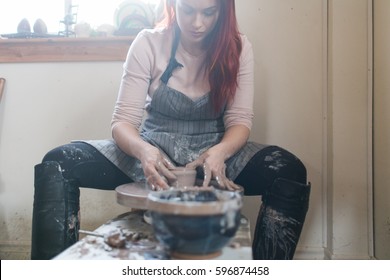 A potter wheel throwing in a studio