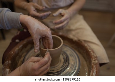 Potter Working On Potters Wheel Making Ceramic Pot From Clay In Pottery Workshop