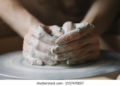 Potter's hands working with raw clay making potttery, ceramic studio workshop, traditional craft  - Powered by Shutterstock