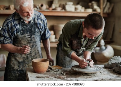 Pottery artist working on pottery wheel - Powered by Shutterstock