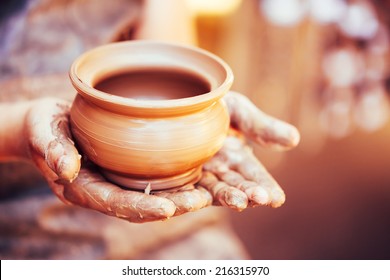 Pottery Craft Ceramic Clay In Potter Human Hand. Toned Instant Photo - Powered by Shutterstock