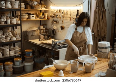 Pottery crafting. Woman sculpting with clay at table - Powered by Shutterstock