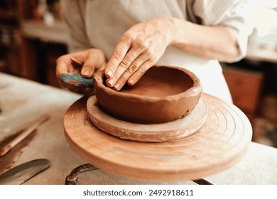 Pottery, hands and artisan in workshop for molding bowl for creative small business manufacturing. Sculpt, diy and person with clay, ceramic and handmade craft project for artistic skill in studio. - Powered by Shutterstock