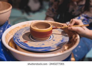 Pottery lesson master class for kids children, process of making clay pot on pottery wheel, potter hands creating ceramic crockery handcrafts, ceramist molding and painting jar or vase - Powered by Shutterstock