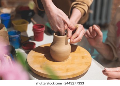 Pottery lesson master class for kids children, process of making clay pot on pottery wheel, potter hands creating ceramic crockery handcrafts, ceramist molding and painting jar or vase - Powered by Shutterstock