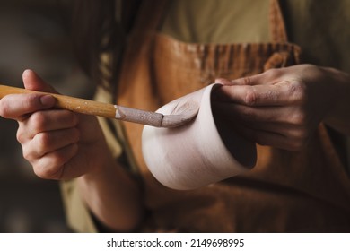 Pottery making, Female potter hands glazing clay cup