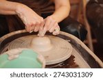 Pottery making process in a craft studio with hands shaping clay