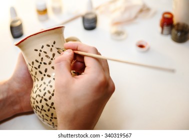 Pottery. Painting pottery.