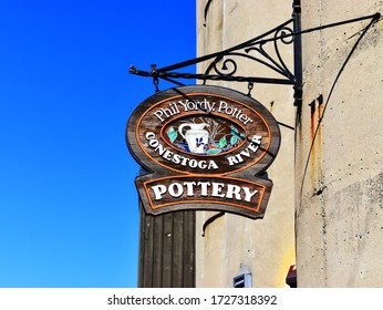 Pottery store woody sign, Conestoga river in St.Jacobs, Ontario, Canada in May 3, 2020  